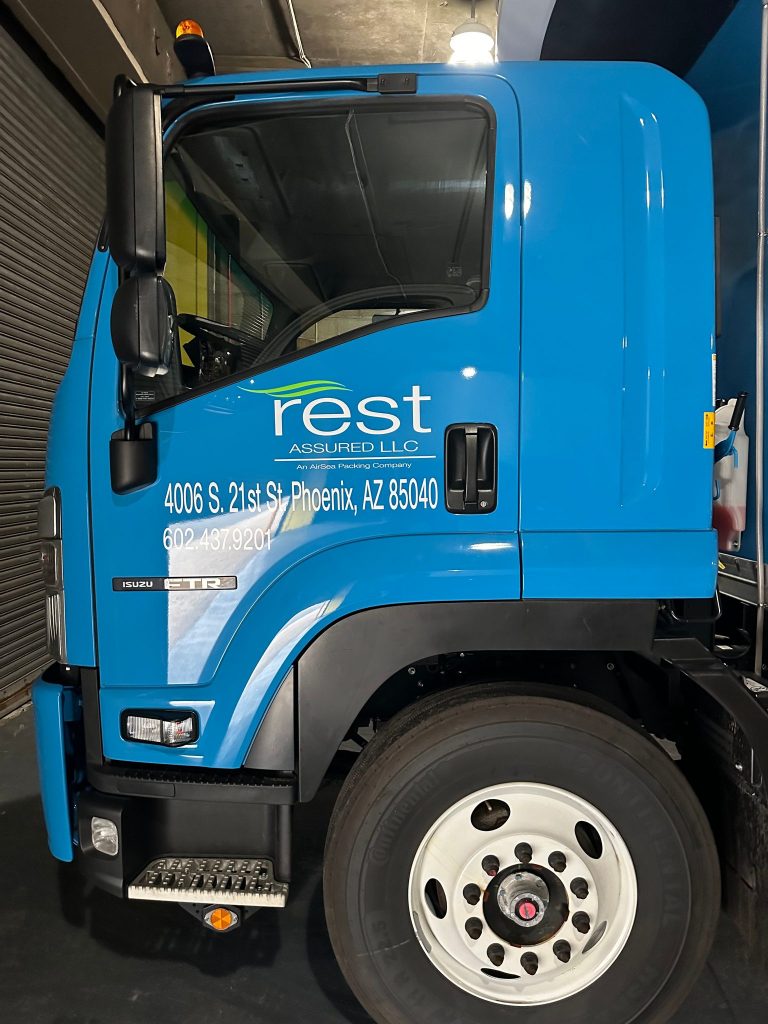 Rest Assured Isuzu truck cab door with vinyl logo and address lettering by Vinyl Images NY